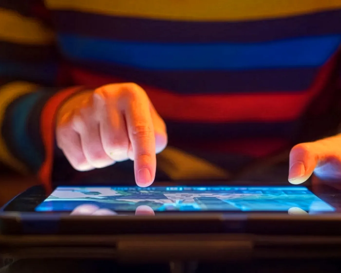A child tapping a tablet screen