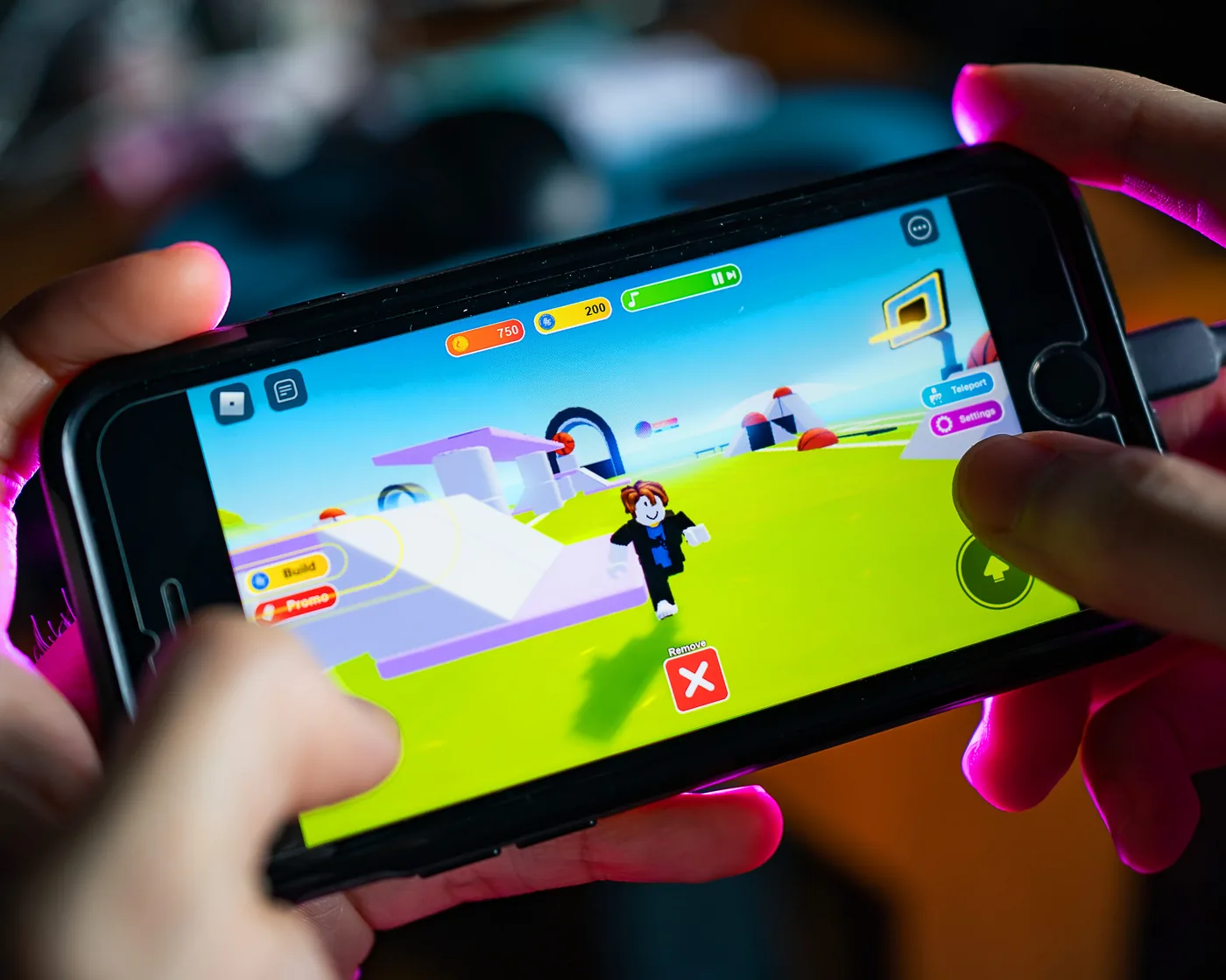 A child playing a Roblox experience on a phone